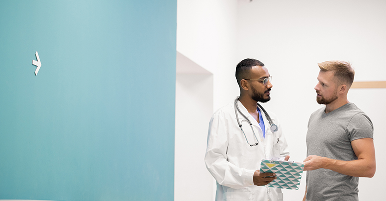 man consulting with male doctor