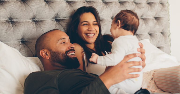happy parents holding up their baby