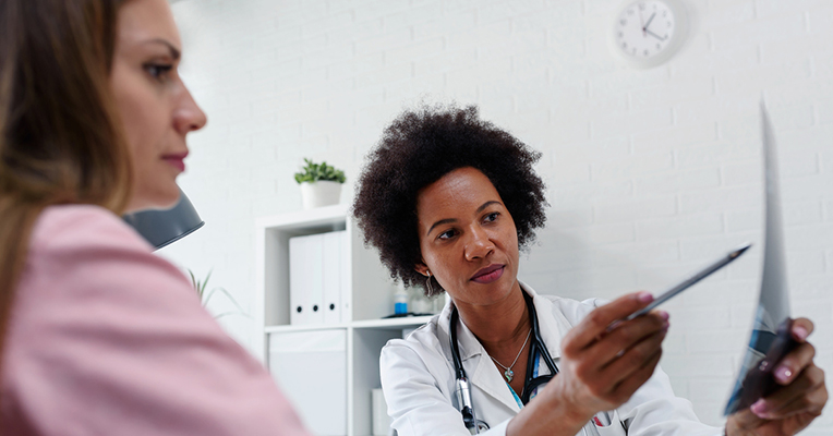 Female doctor explaining result to patient