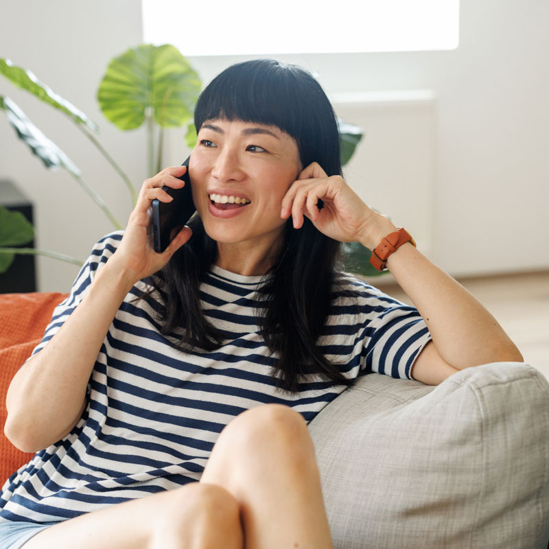 woman on the couch talking on the phone