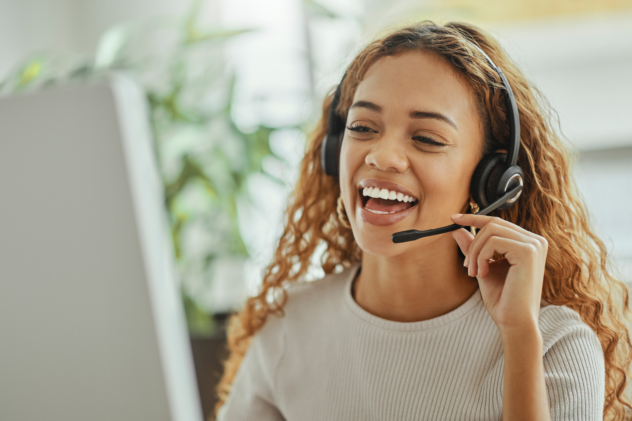 happy woman on headset speaking to patient