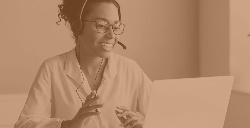 woman on the phone in front of laptop