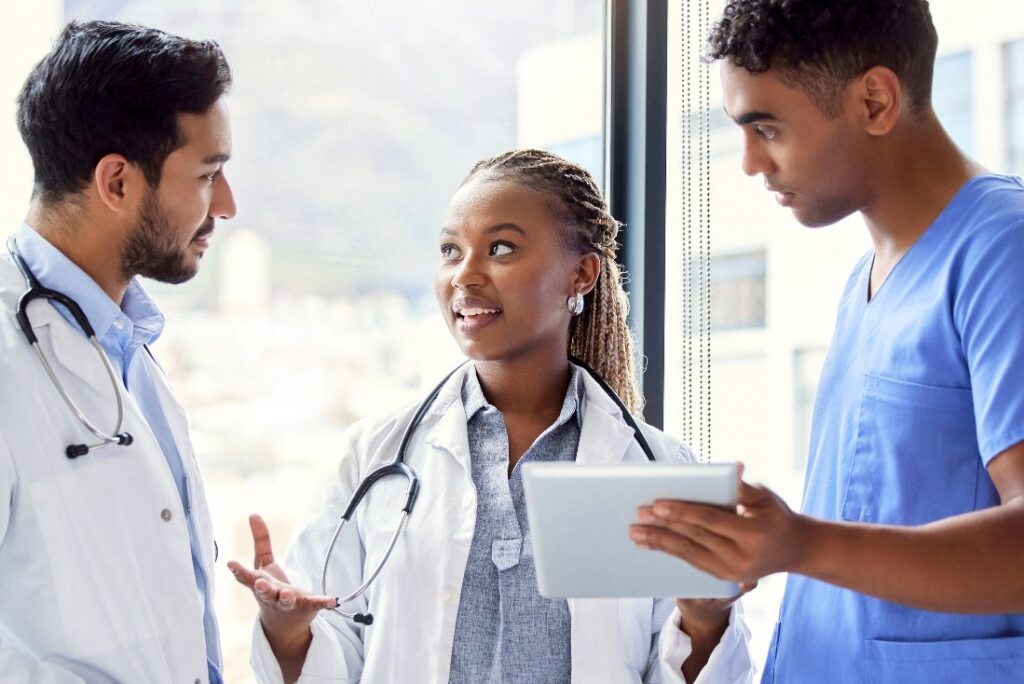 providers discussing a case in the hallway