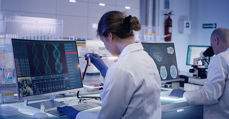 scientists in lab looking at DNA