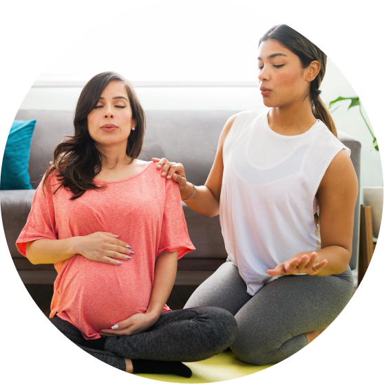 pregnant woman and friend doing breathing exercises