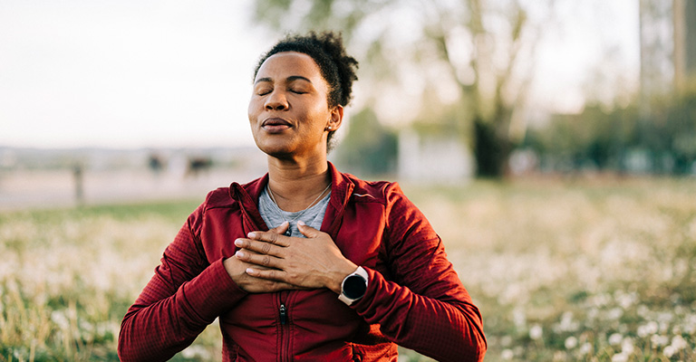 meditating woman seated with eyes closed