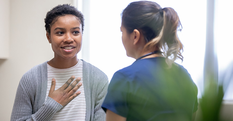 nurse explaining good news to female patient