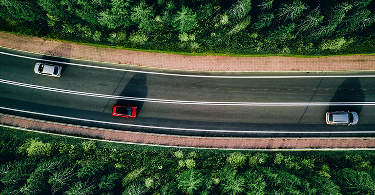 overhead shot of cars driving on highway