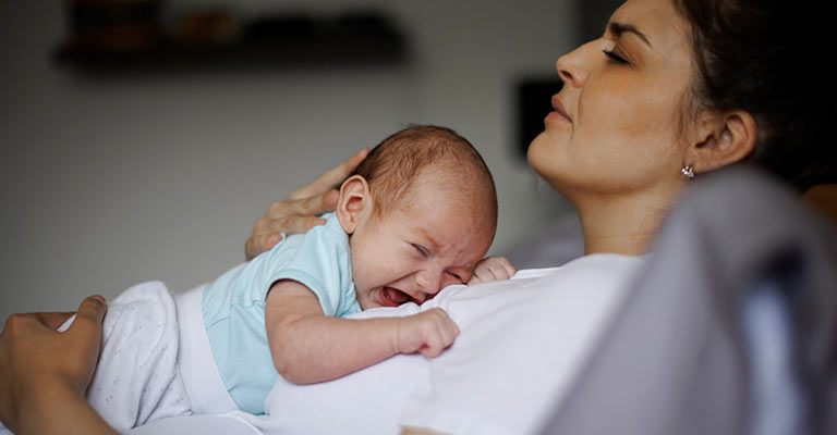 recumbent mother and baby