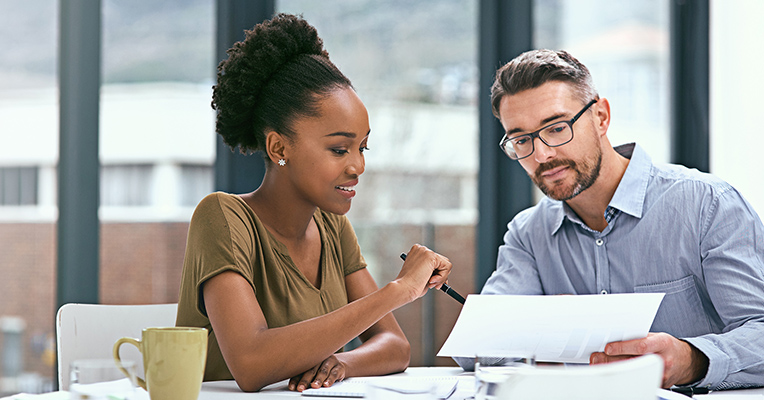 two colleagues reviewing benefits