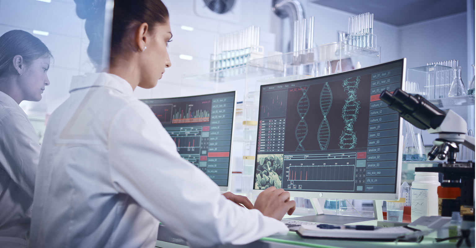 seated researchers in a lab looking at computers