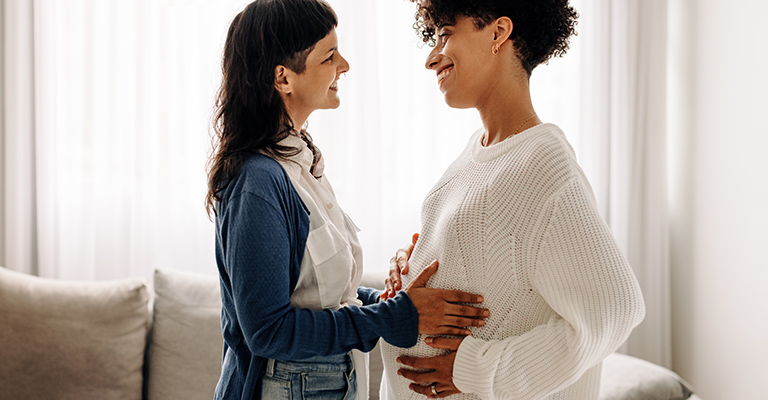 smiling female pregnant couple