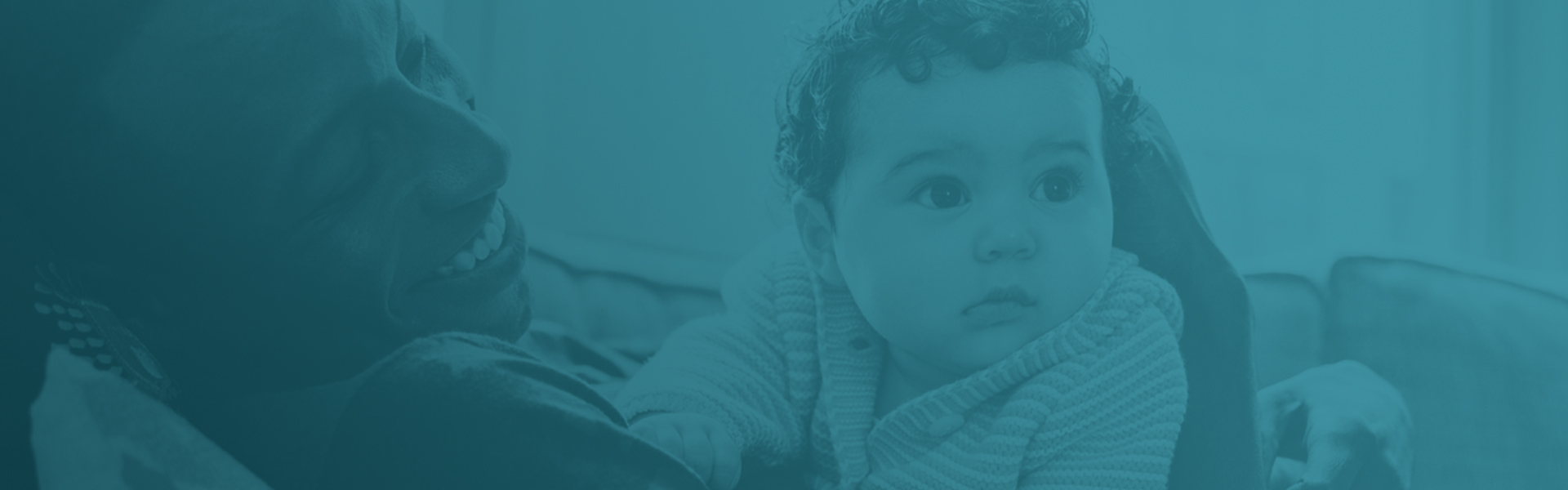 reclined man smiling at baby