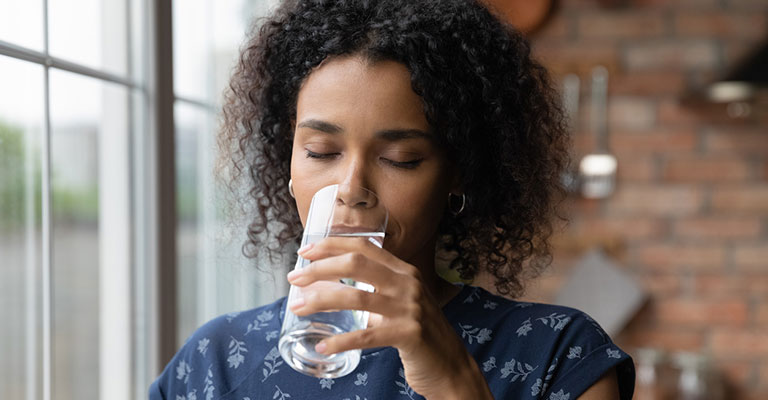 woman drinking a glass of water