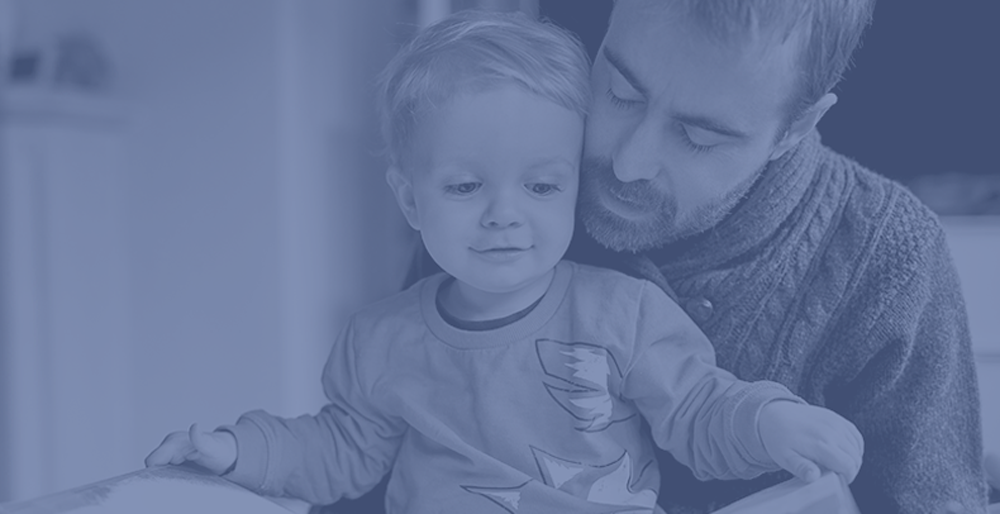 father holding child on a blue background