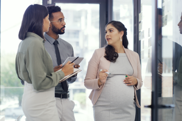 pregnant woman talking with two colleagues
