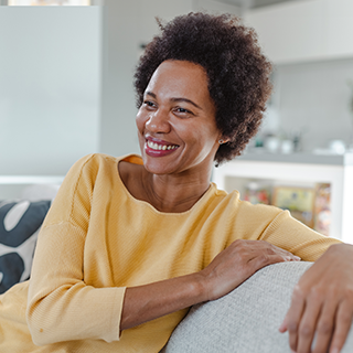 smiling Black woman on couch