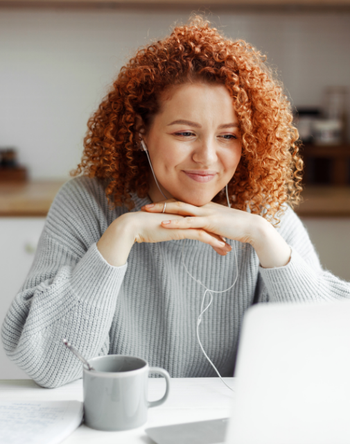 woman looking happily at laptop
